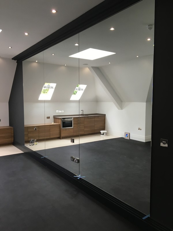 Frameless glass partition in loft conversion by Southgate glaziers