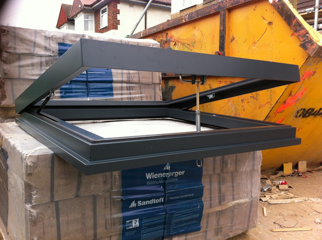 Opening flat roof skylight in anthracite grey installed in Southgate